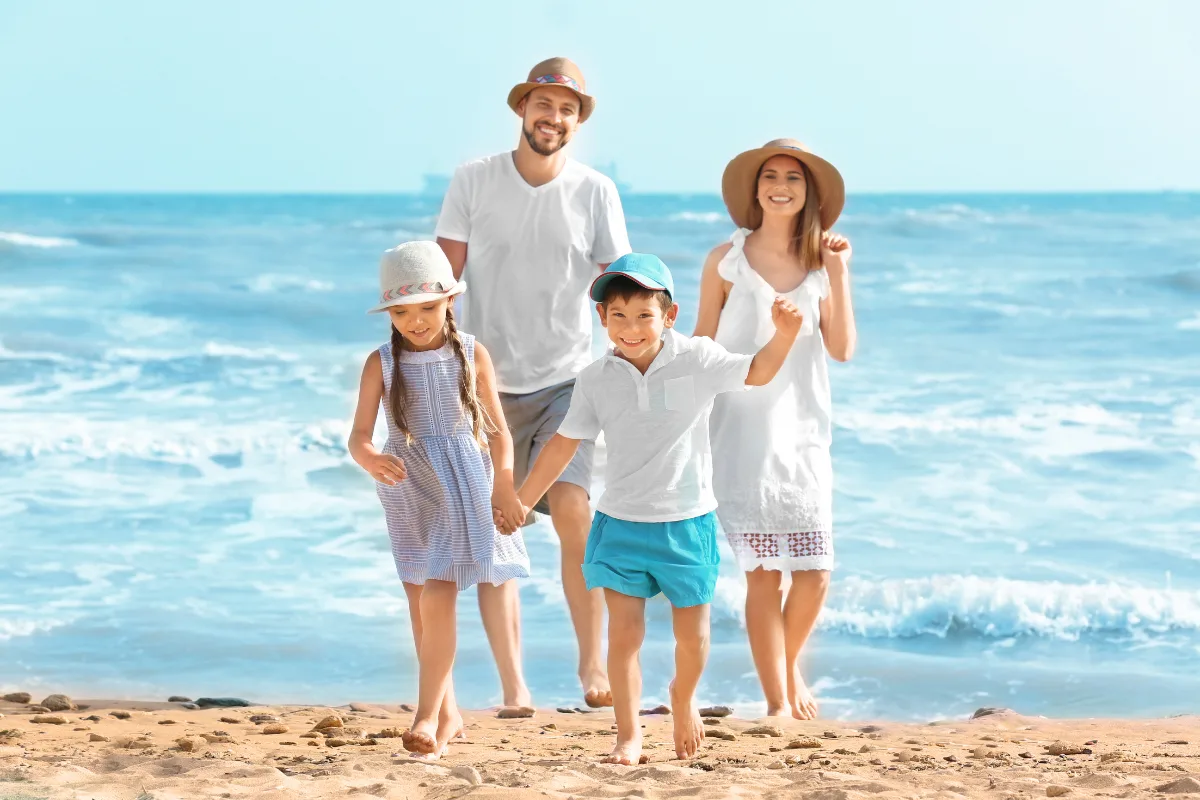 Happy family walking on the beach during summer holidays in Halkidiki, Greece