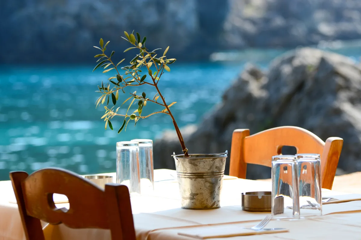 Traditional Greek taverna with sea view and olive tree decoration in Halkidiki