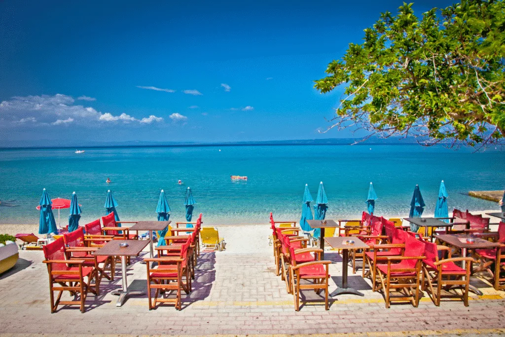 easide view from a café at Pefkochori Beach in Halkidiki, overlooking the turquoise Aegean Sea.